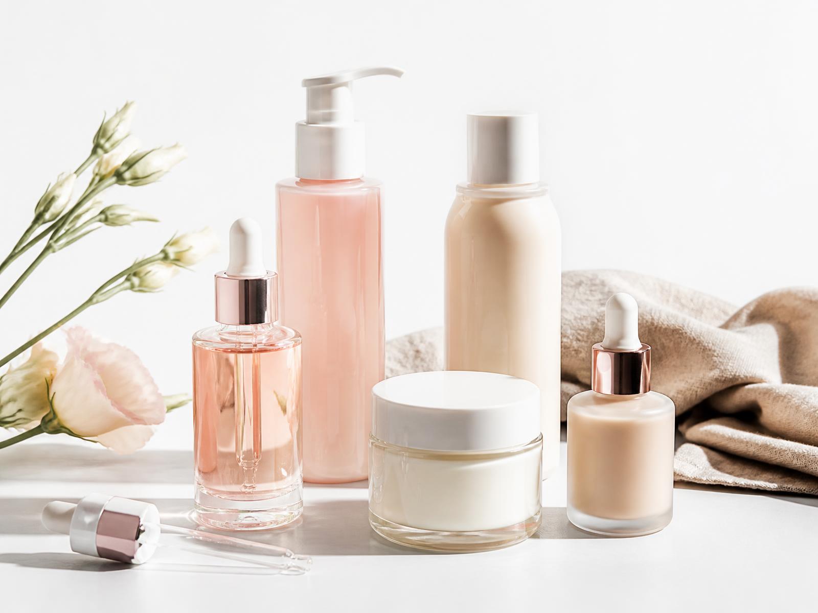 Beauty products arranged on a pale studio surface